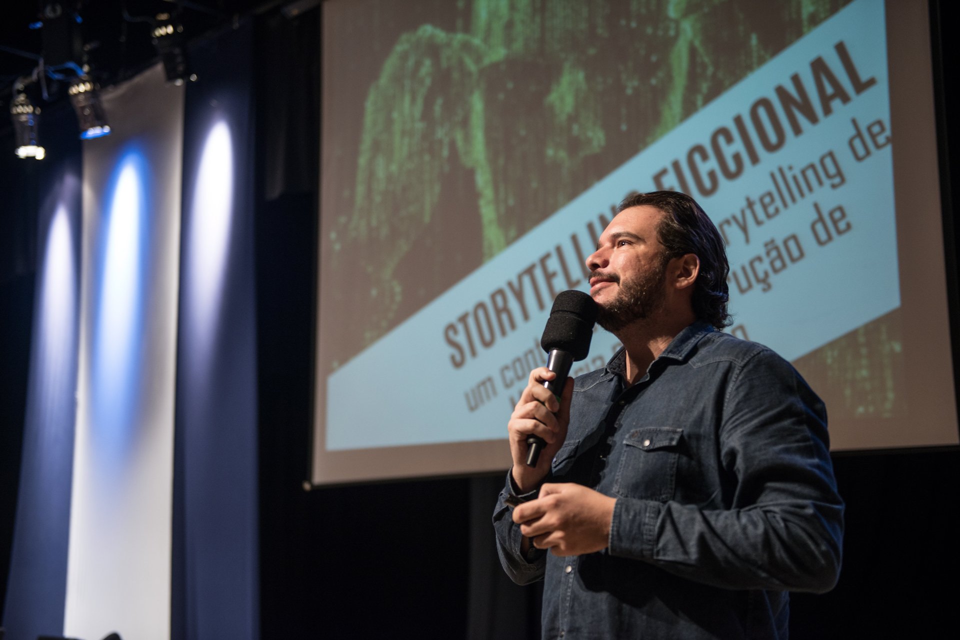 Fernando Palacios speaking on stage with a slide titled fictional storytelling behind him